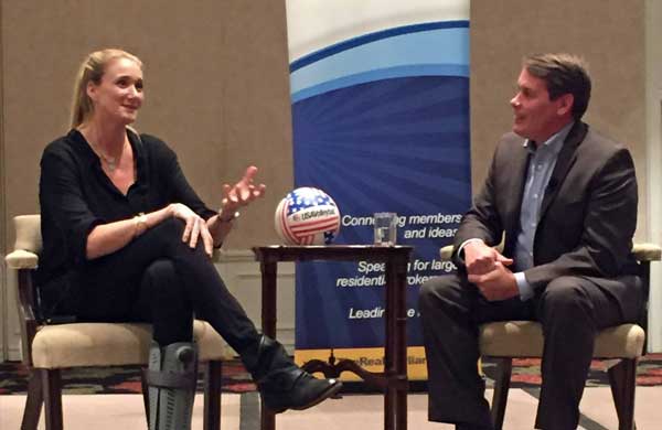 Craig Cheatham listening to a woman from the Realty Alliance